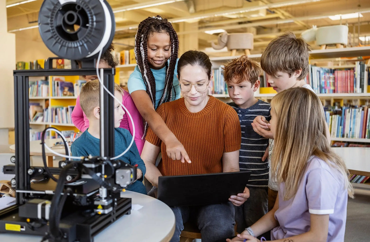 Australian teacher and school students learning 3D printing in a STEM classroom.